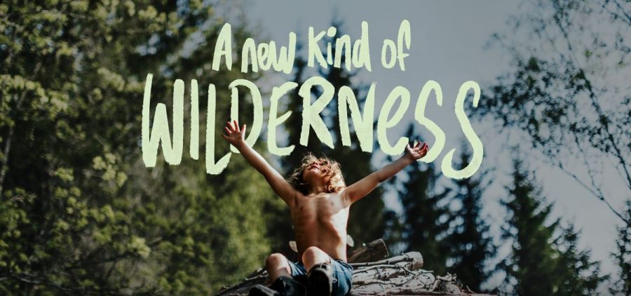 A child sits freely with his arms up in a wooded area. "A new kind of wilderness" is displayed in text above him.