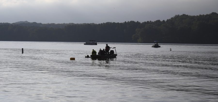 Members of a dive team on Atwood Lake float over a spot where they recovered a body.