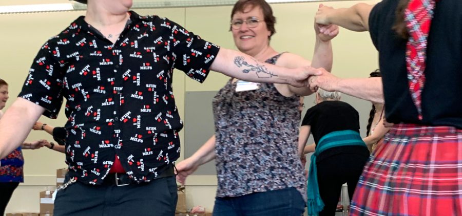 An image of people dancing in a dance class.