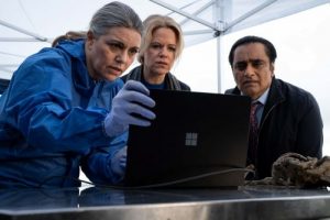 Dr Leanne Balcombe, DCI Jess James, DI Sunny Khan all look at an open laptop.