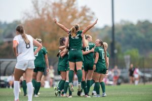 Scout Murray (22) being lifted up after assisting on Anna Burchett's second-half goal against Akron.