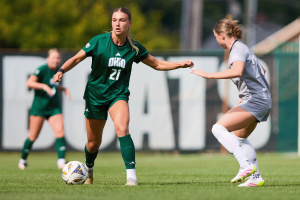 Quintin Tosetevian (21) dribbles past an NKU defender on Sept. 4, 2025. Ohio University ties Northern Kentucky University 1-1 in women’s soccer on September 4th, 2025 at Chessa Field.
