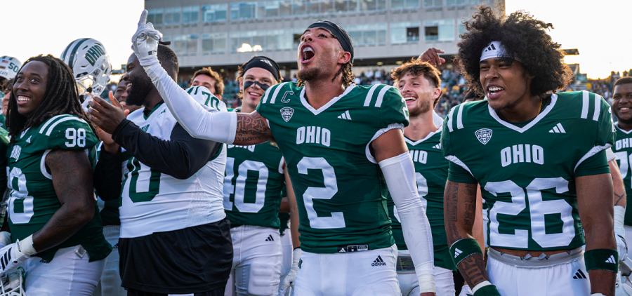 Ohio Football players celebrating with the student section after the team's 17-10 win over West Virginia.