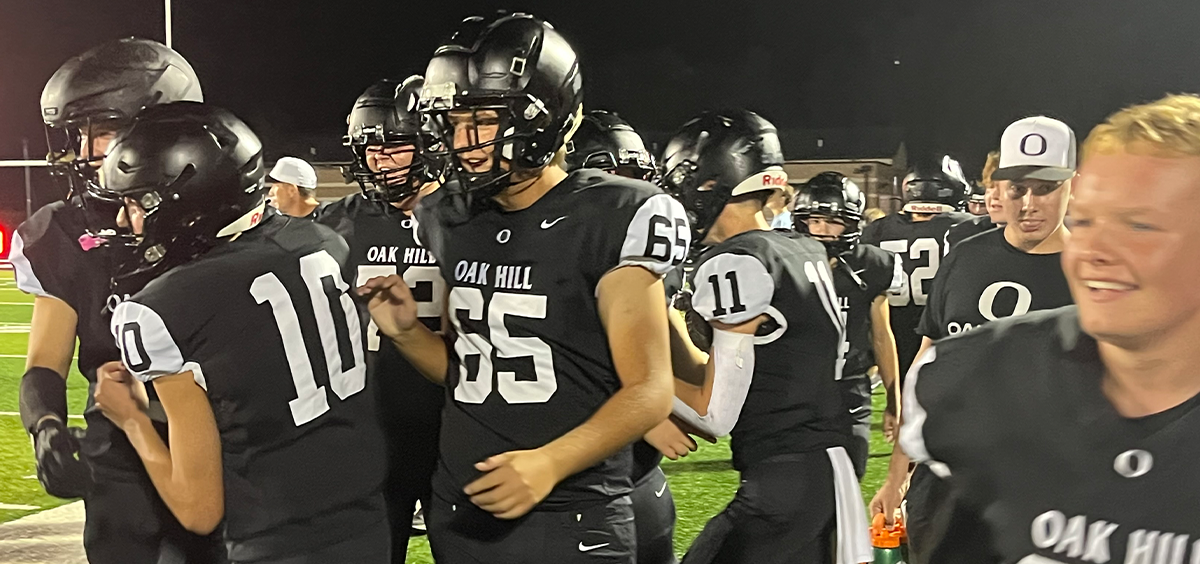 Oak Hill players celebrate and embrace after first win