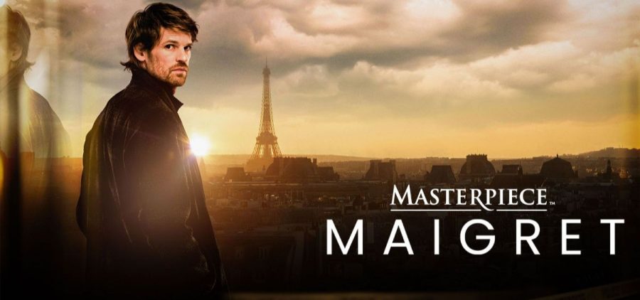 Jules Maigret (Benjamin Wainwright) stands on the left side looking over his right shoulder into the camera. A city sky line displayed in the distance.