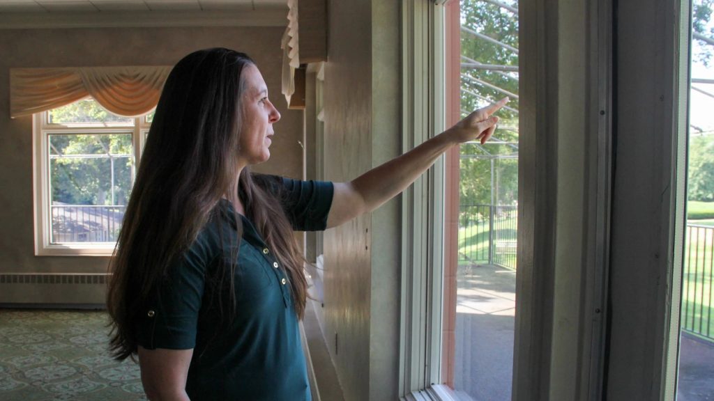 Ohio History Connection Chief Historic Sites Officer Jennifer Aultman points to the Octagon Earthworks from the second floor of the former Moundbuilders County Club clubhouse.