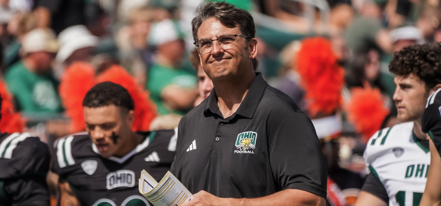 Ohio Football head coach Brian Smith smiling on the sideline during Ohio's game against Bowling Green.