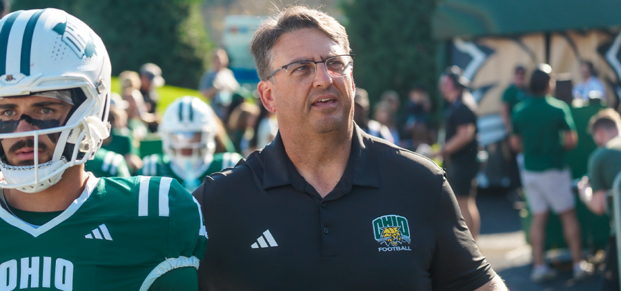Ohio Football head coach Brian Smith walking onto the field before the game against Northern Illinois.