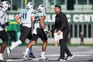 Ohio Football head coach Brian Smith celebrating with the defense after getting a stop vs EMU.