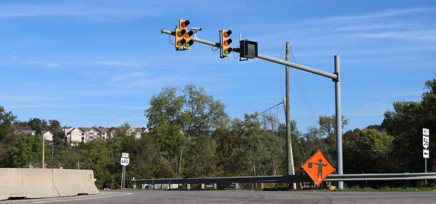 A traffic light and road work signage at the intersection of state routes 682 and 56.