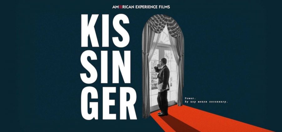 Henry Kissinger looks out the windows of a French door.