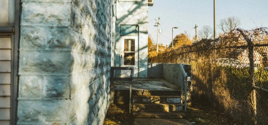 A multi family housing unit as seen down an alley.