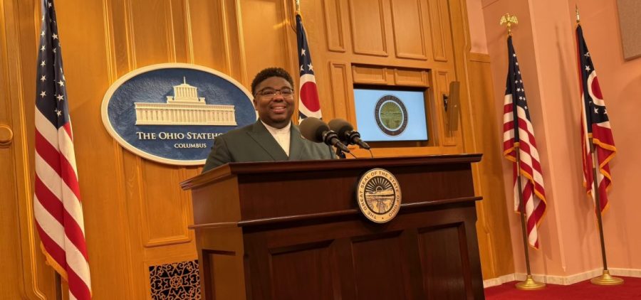 Rep. Dontavius Jarrells stands at a podium during a press conference.