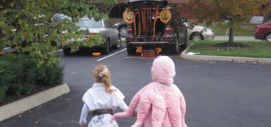 Kids walk to a car at a "trunk or treat" event in central Ohio
