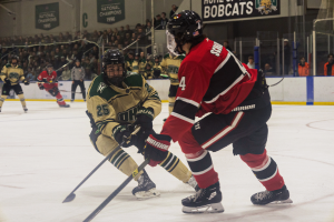Ohio Hockey forward Hollander Thompson forechecking against Illinois State.