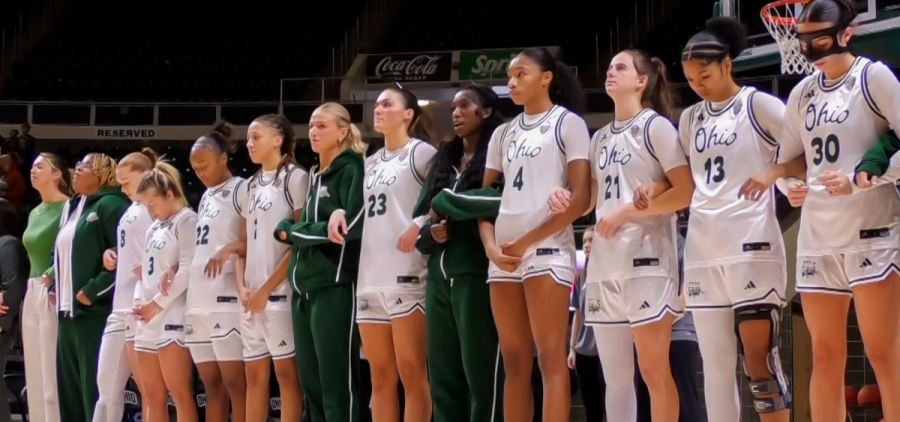 The Ohio Women's Basketball team standing together during the national anthem before facing Morehead State.