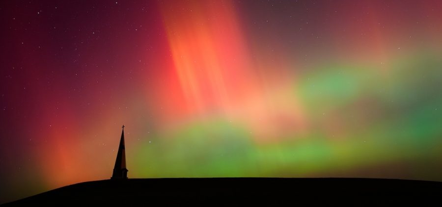 The northern lights fill the sky behind the Saint Joseph the Woodworker Shrine