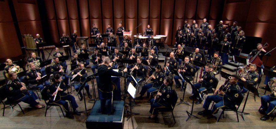 The US Army Field Band pictured on stage preforming.
