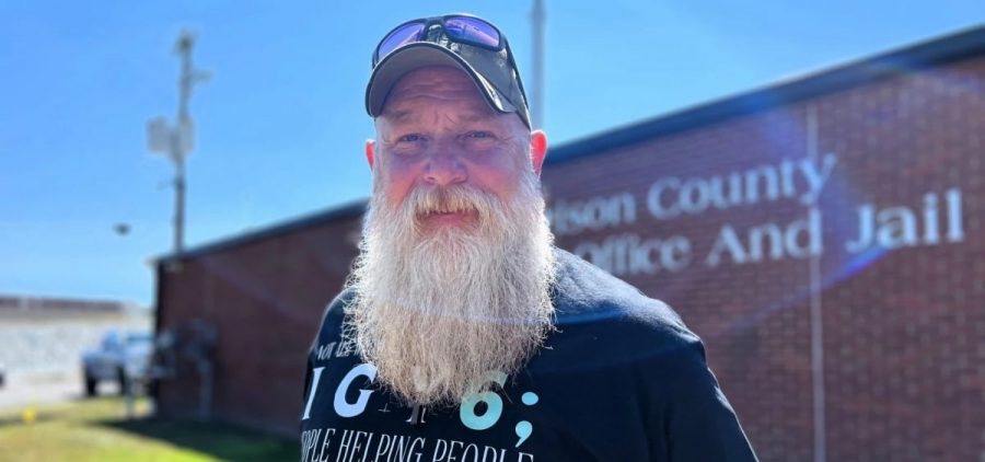 Ohio veteran Dirk Harkins stands outside of a brick building