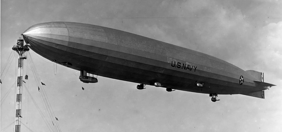 The USS Shenandoah is parked in the sky in this black and white photo.