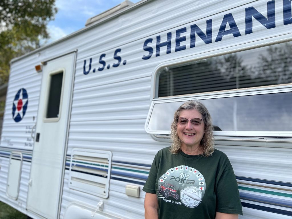 Theresa Rayner stands in front of her mobile museum: a trailer dedicated to telling the story of the USS Shenandoah.