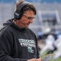 Ohio Football head coach Brian Smith looking at his play sheet against Buffalo.