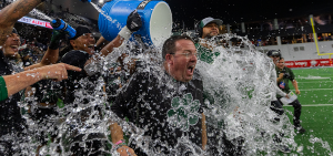 Ohio Football interim head coach John Hauser getting splashed with water after winning the Frisco Bowl.