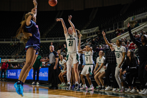 Ohio Women's Basketball guard Bailey Tabeling shooting a late three in front of the Ohio bench vs UIC.