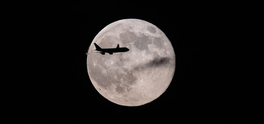 A UPS Boeing 747 inbound from Anchorage, Alaska, passes in front of the supermoon as it approaches Louisville Muhammad Ali International Airport