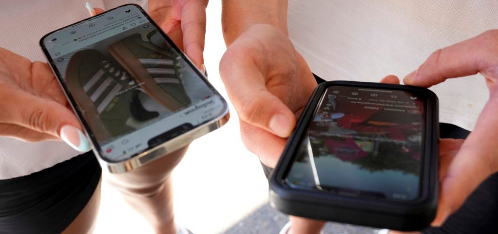 Young persons use their phones to view social media