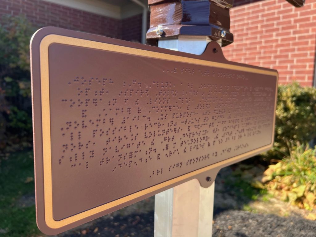 A braille plaque tells the history of the Sight Center of Northwest Ohio.