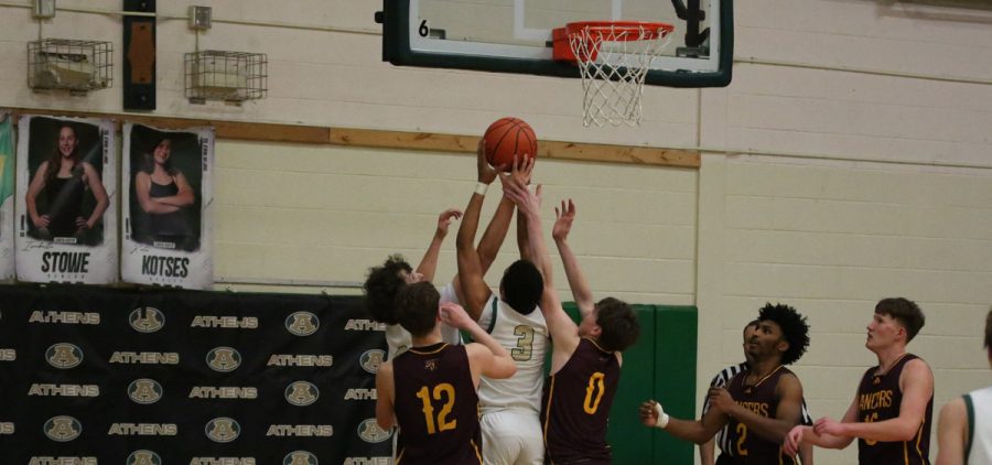 Jackson Warner shooting a layup over several Federal Hocking defenders.