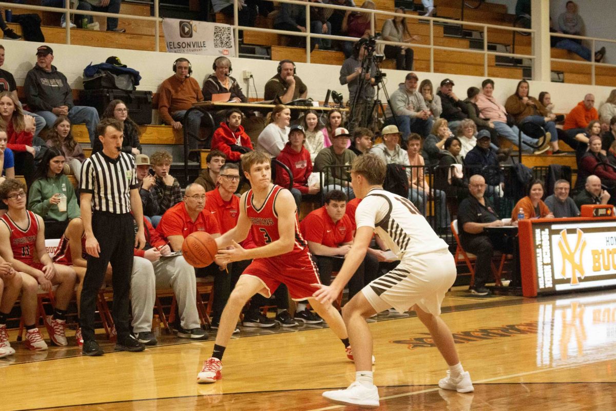 Noah Ray looking to pass the ball while being defended