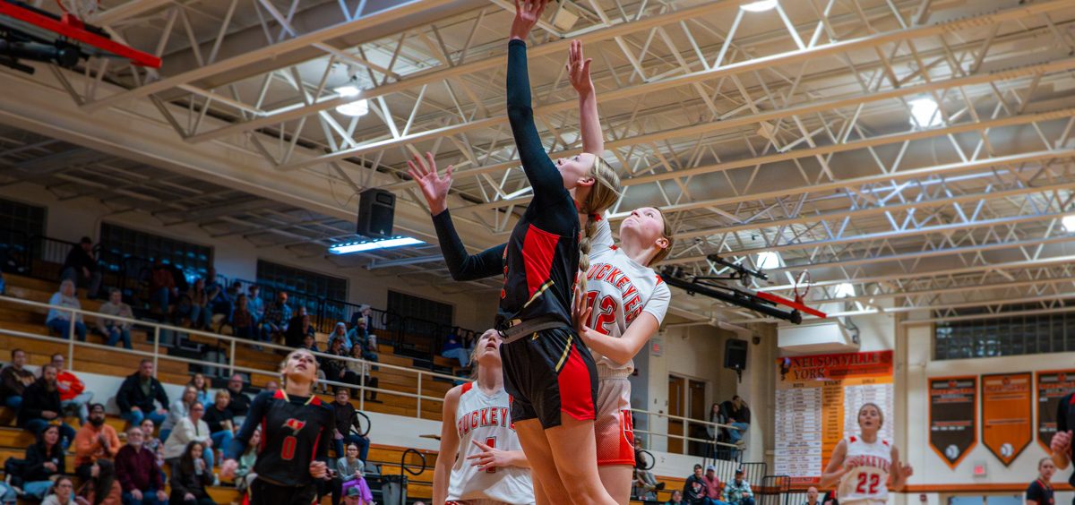 Ora Swisher attempting a block against Ryleigh Shafer in the paint