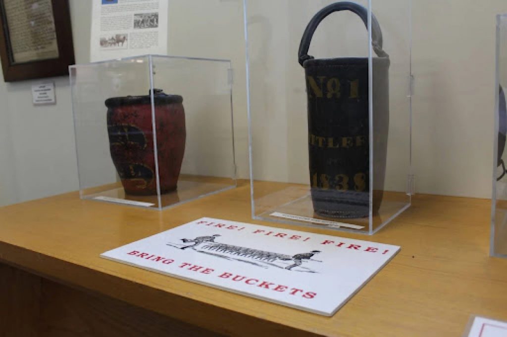Old buckets used to put out fires are on display at a museum.