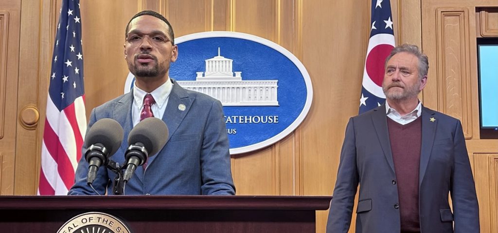 Rep. Josh Williams speaks to reporters about his child care fraud bill, with Republican Attorney General Dave Yost, who supports the bill, alongside him