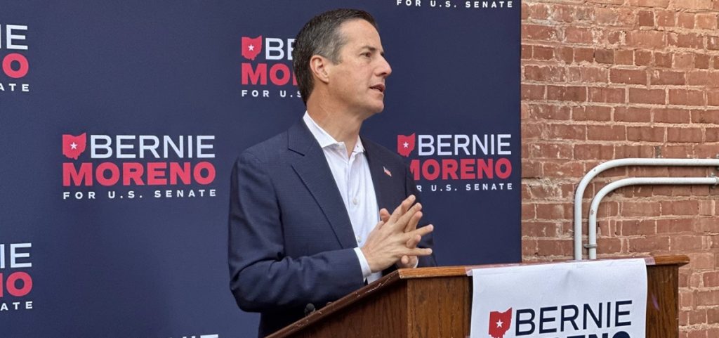 Bernie Moreno stands at a podium and speaks.