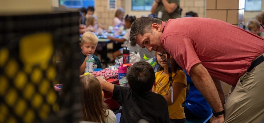 Spanish Immersion School Principal Michael Brennan talks to students during lunch at the K-8 school in Mansfield.