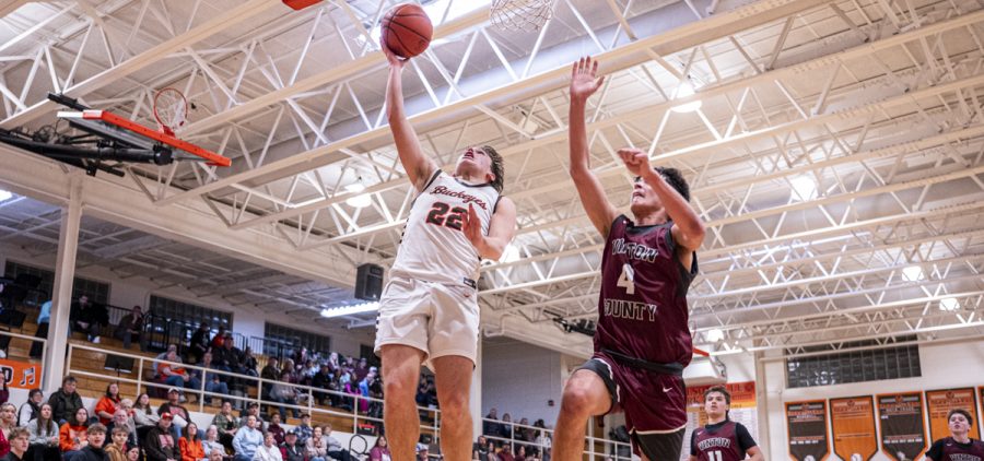 Champ Schultz goes up for the layup while getting trailed by a Vinton County player.