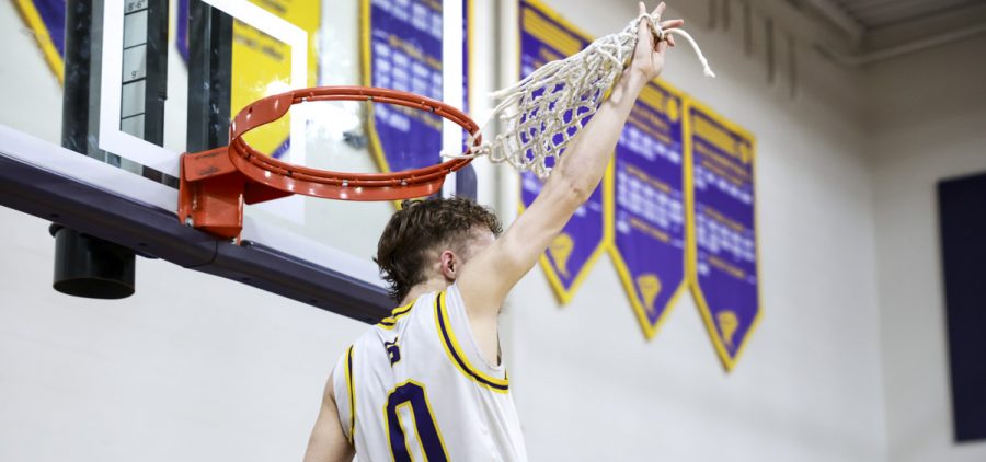 Southern player cuts down the net in celebration of winning the TVC-Hocking title.