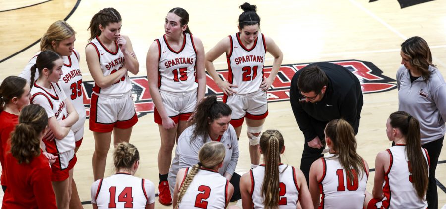 The Lady Spartans huddle around their coach for the gameplan against the Lady Buckeyes.