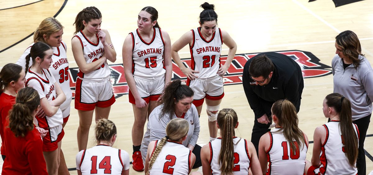 The Lady Spartans huddle around their coach for the gameplan against the Lady Buckeyes.
