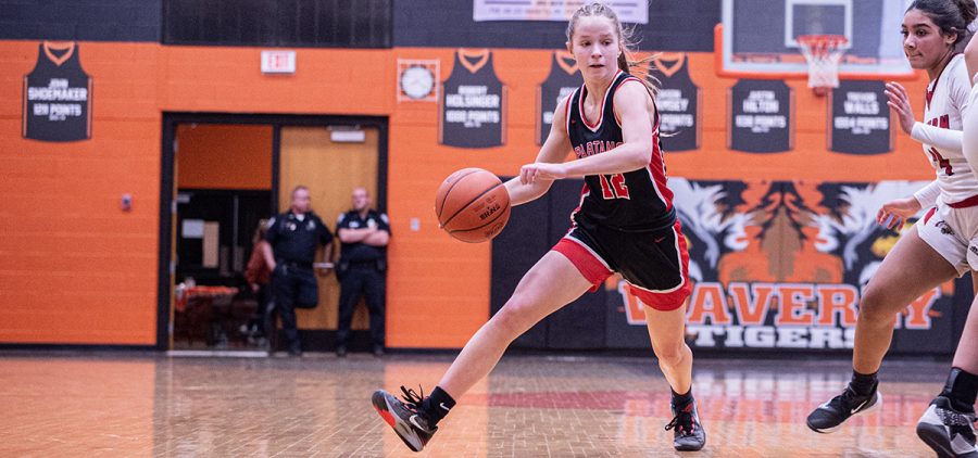 The Alexander Lady Spartan drives by her defender to try and get to the basket for the layup against the Winchester Eastern Lady Warriors.