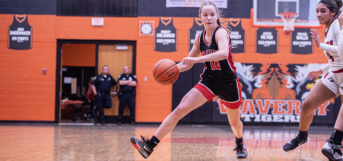 The Alexander Lady Spartan drives by her defender to try and get to the basket for the layup against the Winchester Eastern Lady Warriors.