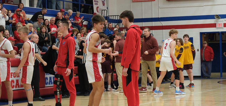The Fort Frye Cadets do a pregame handshake before they face the Federal Hocking Lancers in their final regular season game.