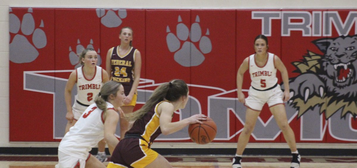 Brenlee Cottrill tries to blow by a Trimble defender to get to the paint.