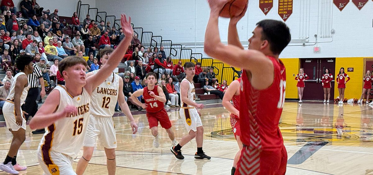 Trimble player goes up for a shot as a Lancer defender closes out on him.