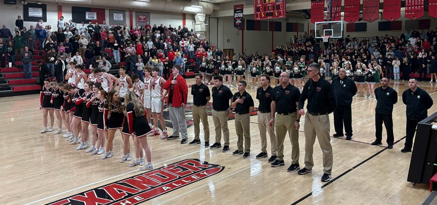 The Alexander Spartans and Athens Bulldogs stand for the Anthem before their matchup in the Alley.