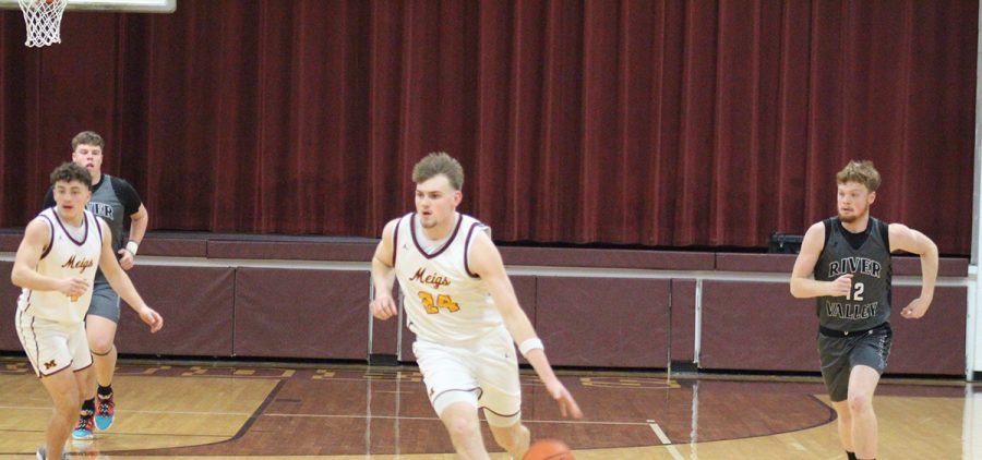 Carson Davis drives the ball down the court against the River Valley Raiders.