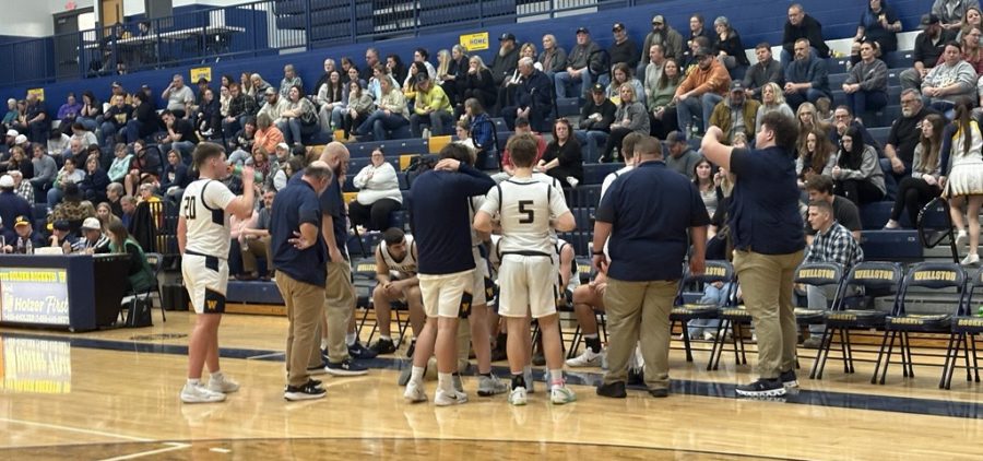 The Wellston squad huddles around their coach for the gameplan against Athens.